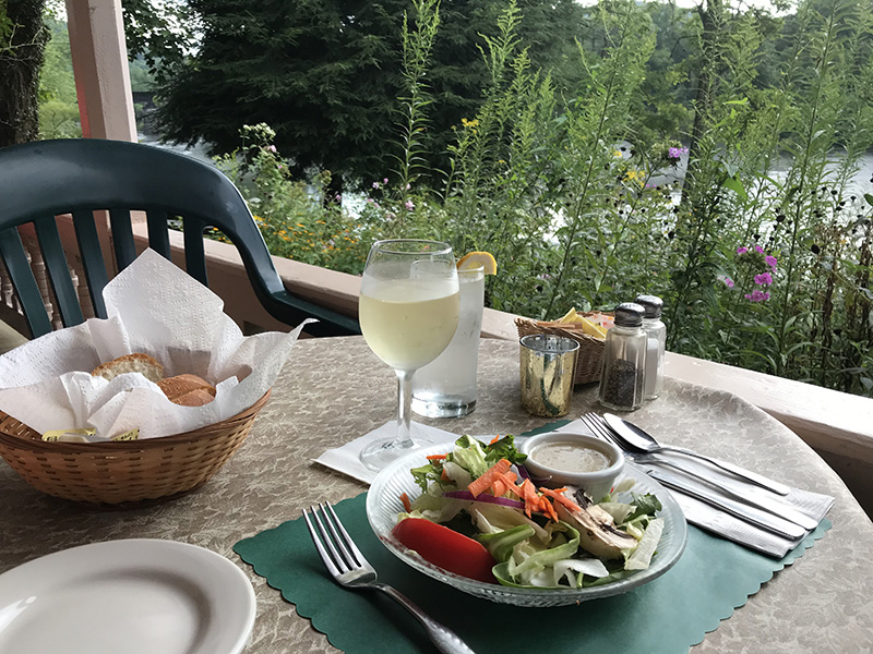 Glass of wine and salad served at River View Cafe