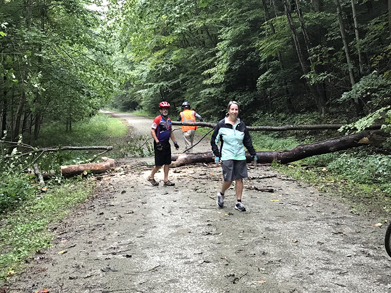 Volunteers clearing a fallen tree from the GAP Trail near mile marker 55