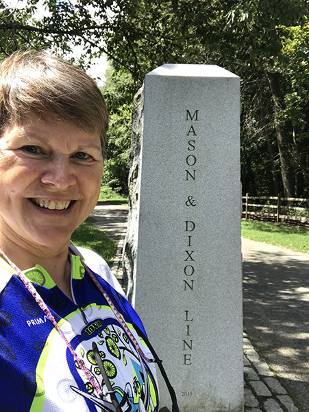 Molly at the Mason-Dixon Line marker