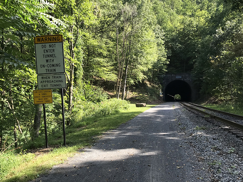 Brush Tunnel - with a sign that cyclists should not enter the tunnel when a train is approaching