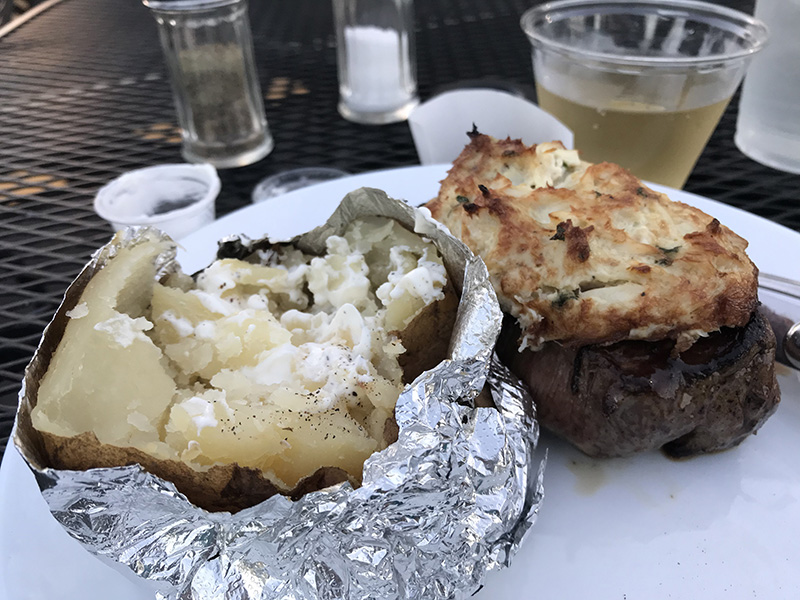 Baked potato and steak topped with Maryland crab imperial