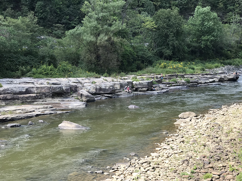 Hikers or cyclists enjoying the waters of Casselman River near Confluence