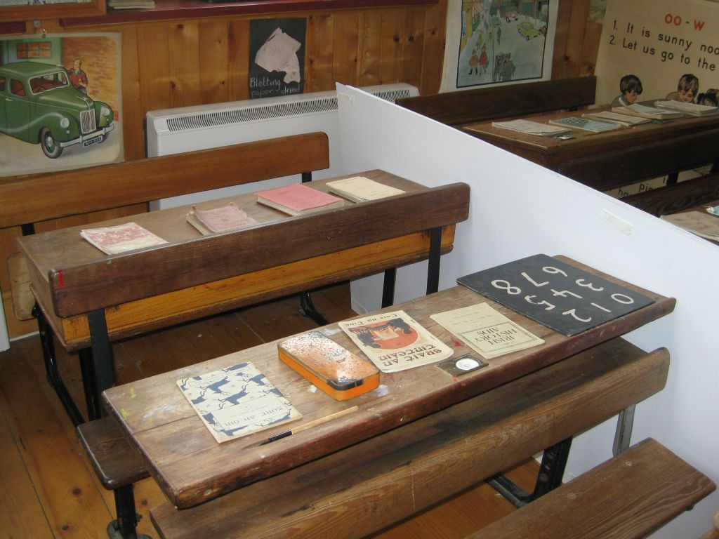 Children's school desks and books, as they would have been 60+ years ago.