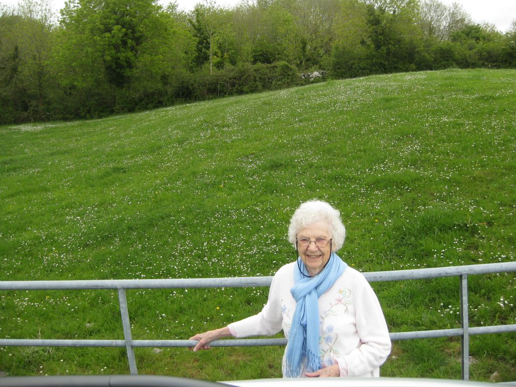Roberta Wheelan Clark, on her 93rd birthday (May 19, 2016) at the site where her grandfather, John Connell Swift was born in the townland of Ballylee, Co. Galway, Ireland. The family home once stood somewhere in the green field behind her. There are no remnants of a house at this location.