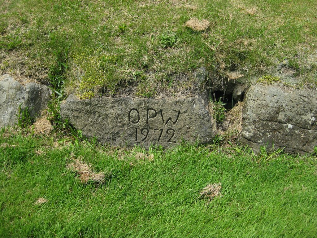 An example of a "new" stone that was placed on the site at Knowth by the Office of Public Works. Stones that were introduced to the site by modern efforts are so marked and dated so their placement is not misrepresented as a work of ancient people.