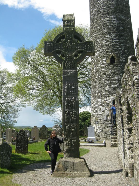 Martha stands beside the Tall Cross or West Cross at Monasterboice.