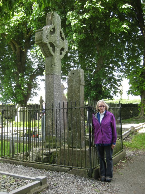 Annis stands beside the north cross at Monasterboice.